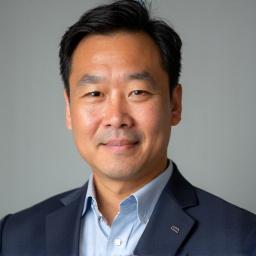 Professional headshot of Kenji Tanaka.